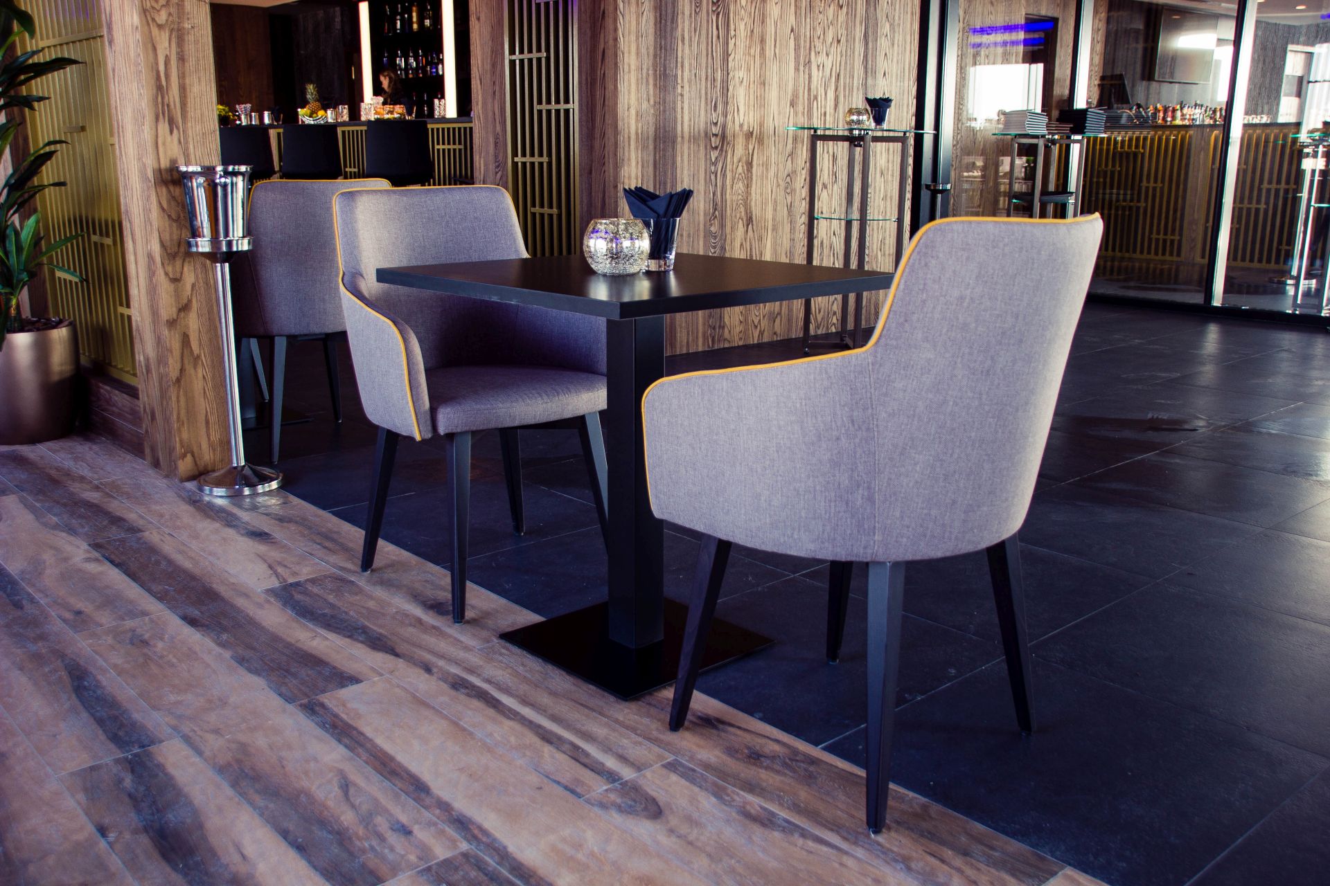 Lounge room details of Stella di Mare hotel. There are 2 modern armchairs with one coffee table.