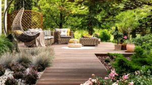 Beautiful wooden outdoor space with garden furniture surrounded by greenery on a warm sunny day